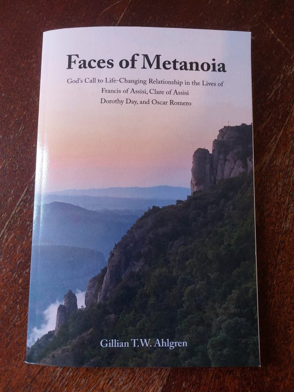 Cover image featuring a photo of a grassy mountainside with hills and a sunset in the background.
